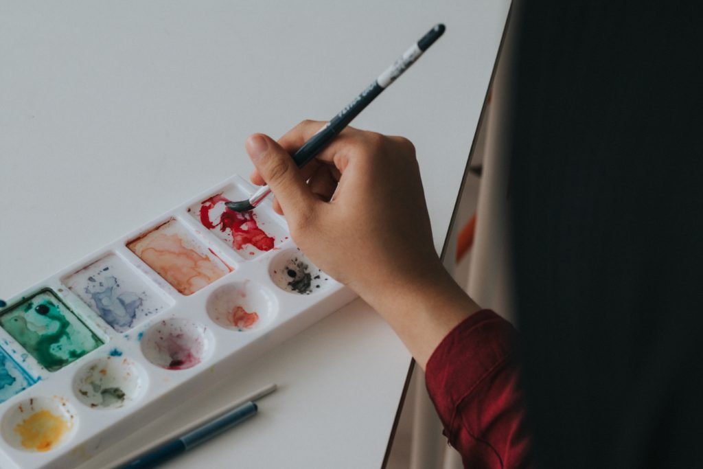 a person painting with watercolors