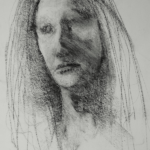 charcoal drawing of a woman's face, with long hair framing both sides